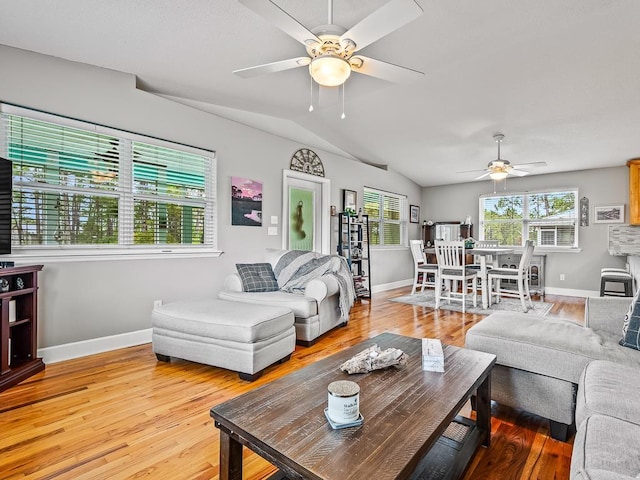 living room with hardwood / wood-style floors, ceiling fan, and lofted ceiling