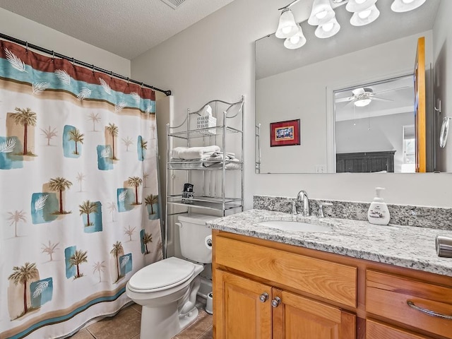 bathroom with ceiling fan, tile patterned flooring, a textured ceiling, toilet, and vanity