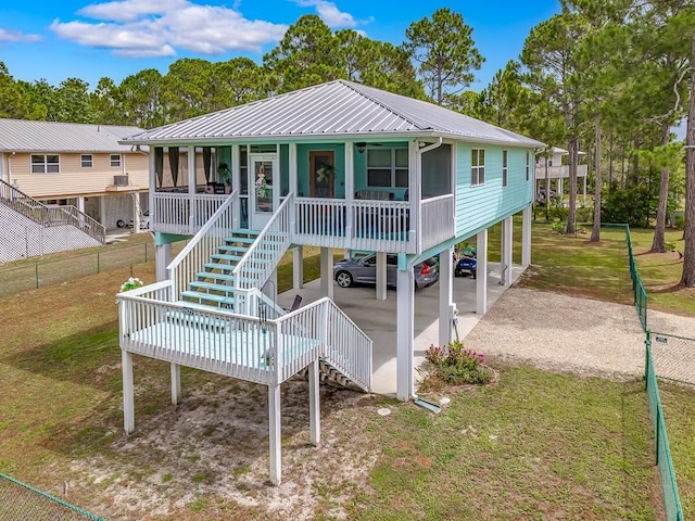 view of front of property with a front yard and a carport