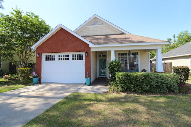 view of front facade with driveway, a front lawn, a porch, brick siding, and a garage