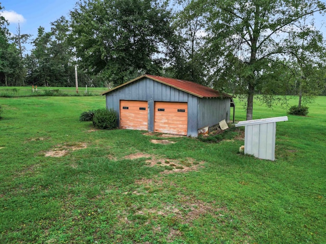 view of outbuilding featuring a lawn and a garage