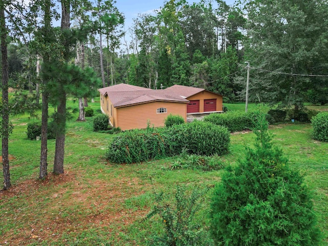 view of side of home featuring a lawn