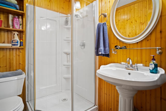 bathroom with walk in shower, wooden walls, and toilet