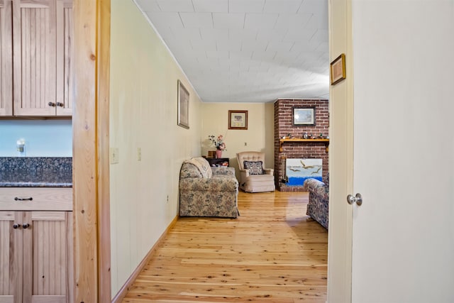 hall featuring light hardwood / wood-style flooring and crown molding