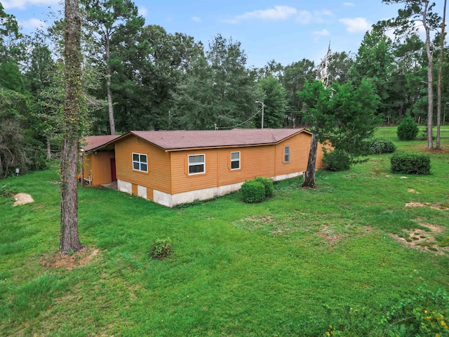 view of property exterior featuring a lawn