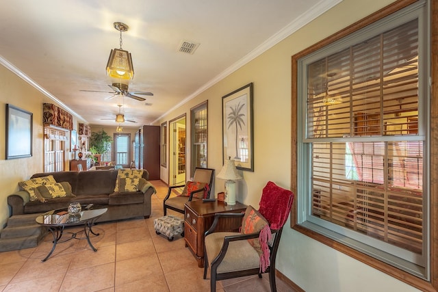 living room with crown molding, light tile patterned floors, and ceiling fan