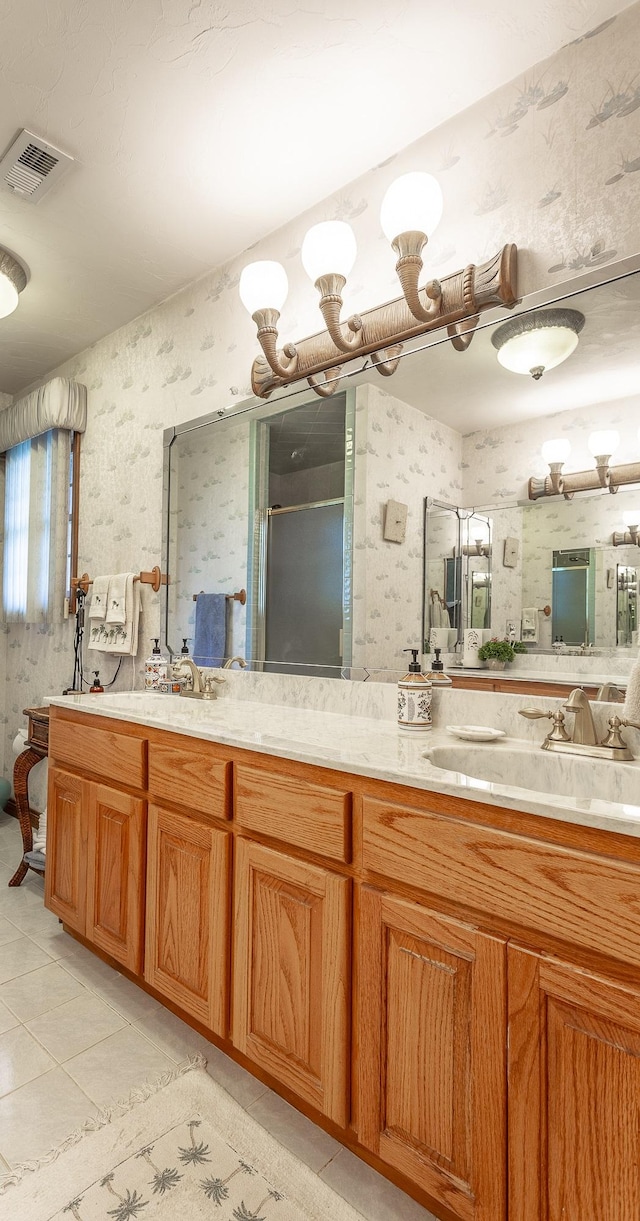 bathroom featuring vanity, tile patterned floors, and a shower with door