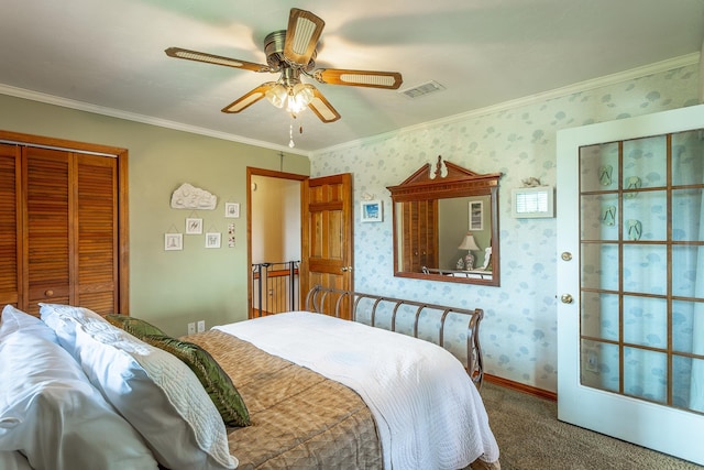 bedroom with carpet flooring, ceiling fan, a closet, and crown molding