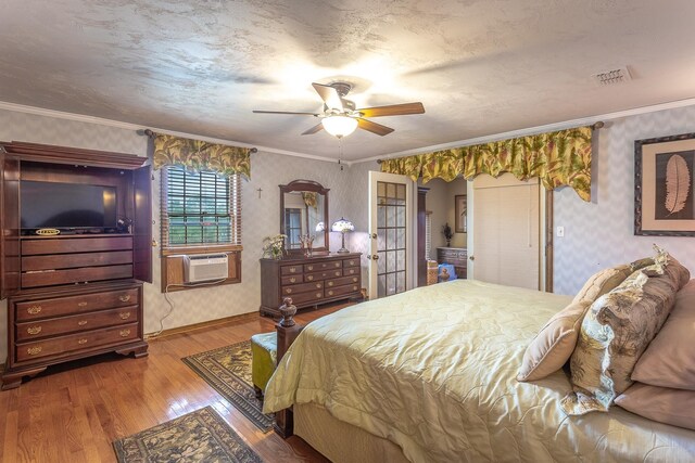 bedroom with ceiling fan, cooling unit, ornamental molding, and hardwood / wood-style flooring