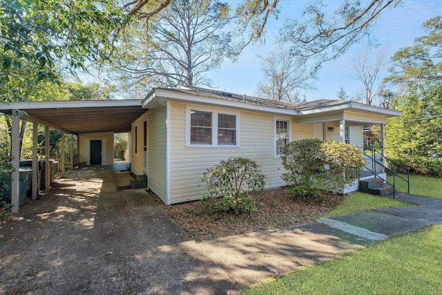 view of front of house with an attached carport and concrete driveway