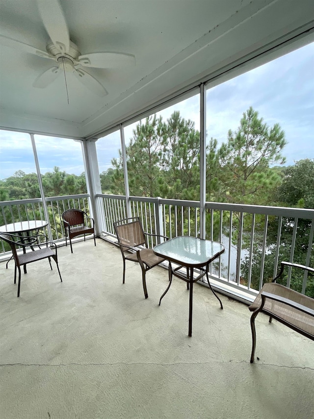 sunroom / solarium with a wealth of natural light and ceiling fan