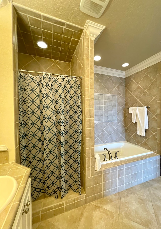 bathroom featuring a textured ceiling, vanity, crown molding, tile patterned floors, and separate shower and tub