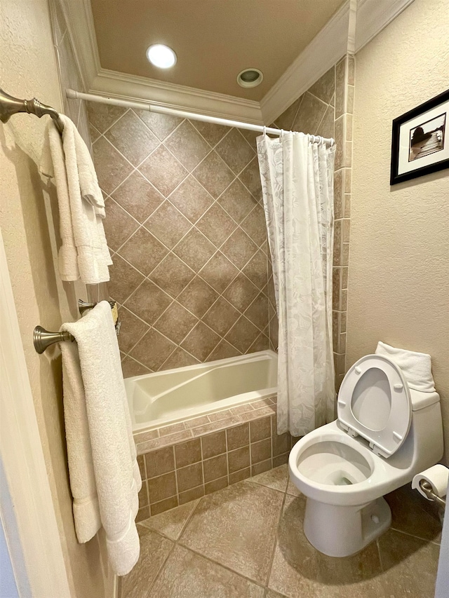 bathroom with toilet, tile patterned flooring, crown molding, and shower / tub combo with curtain