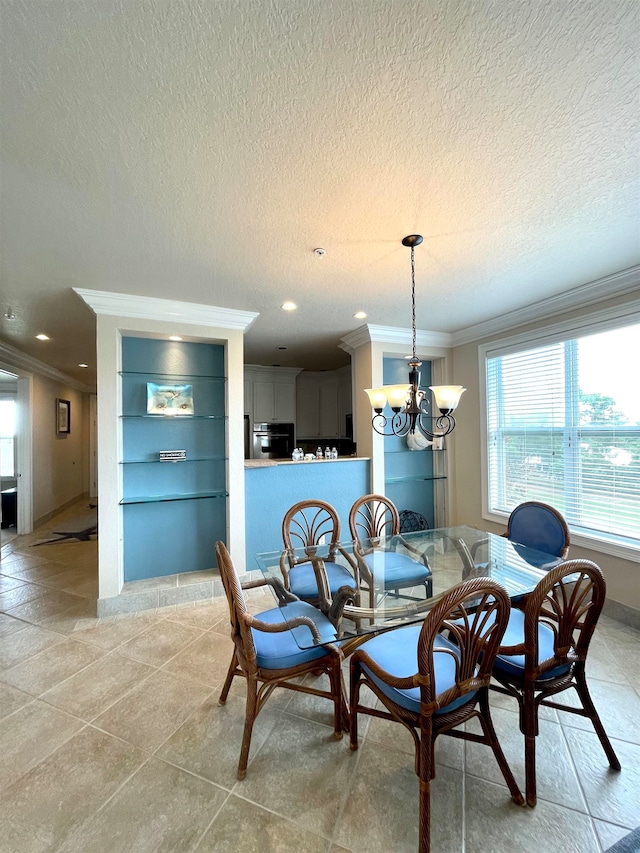 tiled dining area featuring a chandelier, a textured ceiling, and ornamental molding