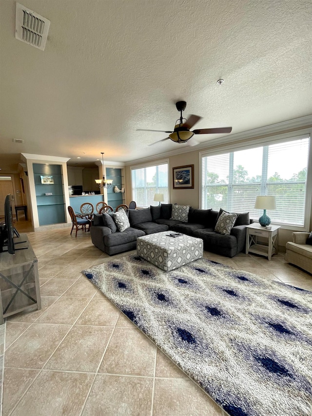 living room with ceiling fan with notable chandelier, a textured ceiling, and tile patterned flooring