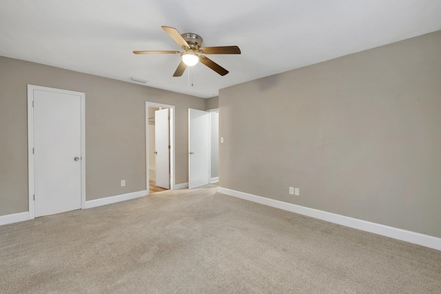 unfurnished room featuring light colored carpet and ceiling fan