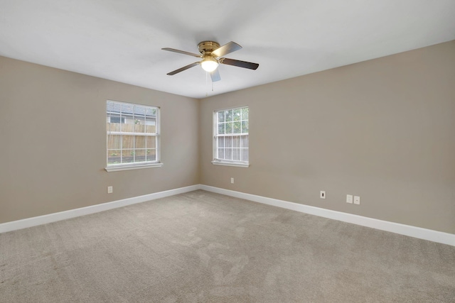 carpeted empty room featuring ceiling fan