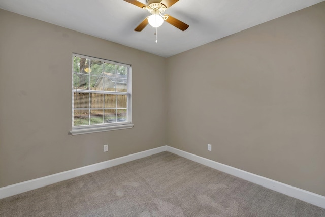 unfurnished room with light colored carpet and ceiling fan