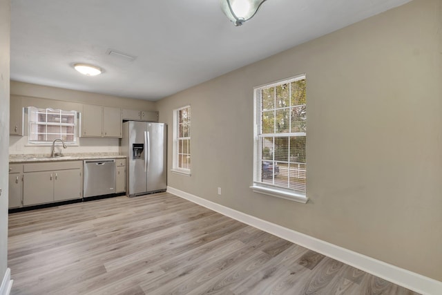 kitchen featuring sink, light hardwood / wood-style flooring, and appliances with stainless steel finishes