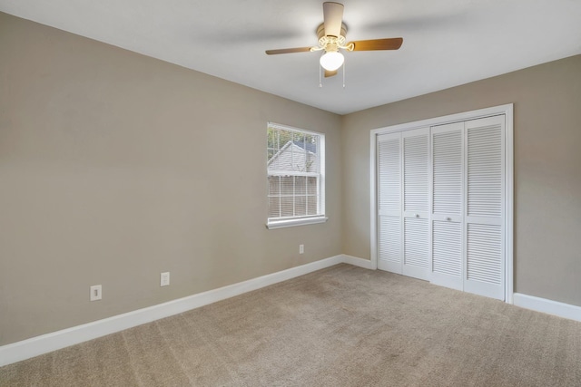 unfurnished bedroom featuring ceiling fan, a closet, and carpet floors