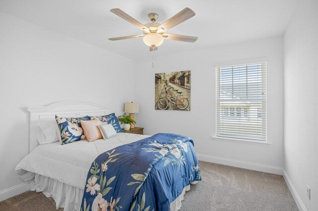 bedroom featuring light carpet and ceiling fan