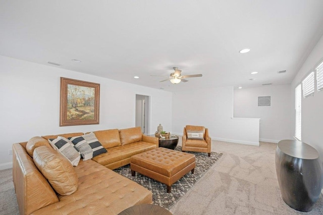 living room with ceiling fan and light colored carpet