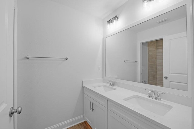 bathroom with hardwood / wood-style floors and vanity