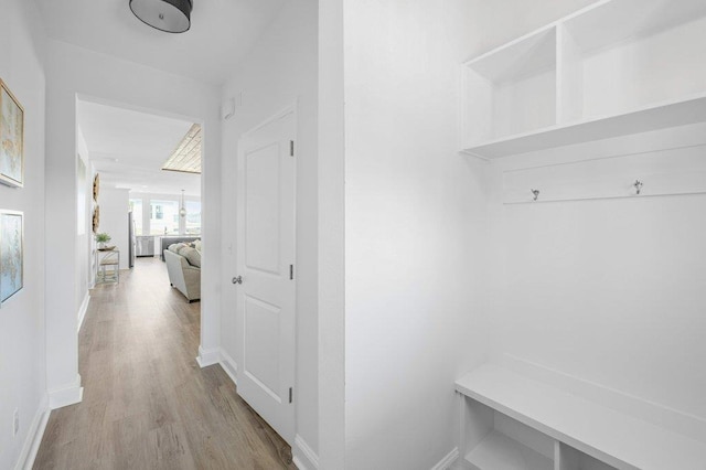 mudroom with light hardwood / wood-style flooring