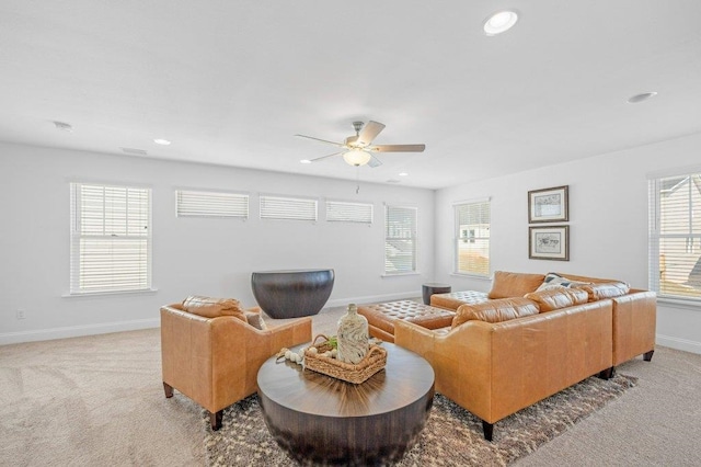 carpeted living room with ceiling fan and plenty of natural light