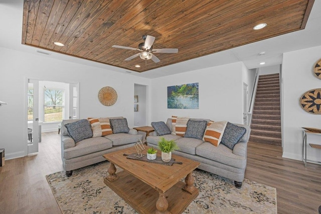 living room with hardwood / wood-style floors, ceiling fan, and wood ceiling