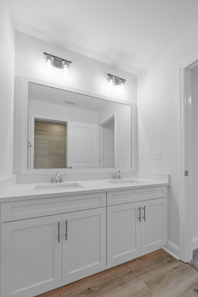 bathroom with hardwood / wood-style floors and vanity