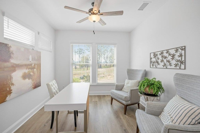 office area with light hardwood / wood-style flooring and ceiling fan