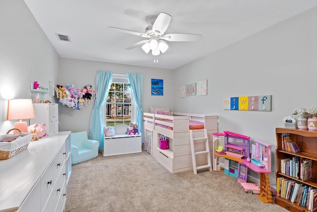 carpeted bedroom featuring a ceiling fan and visible vents