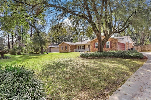 ranch-style house featuring a front lawn, an attached garage, fence, and brick siding