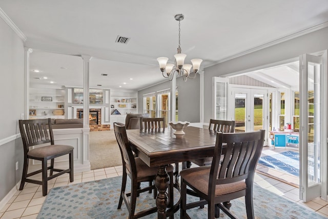 dining area featuring light tile patterned floors, visible vents, ornamental molding, french doors, and a brick fireplace