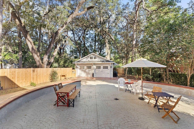 view of patio / terrace with an outbuilding and a garage