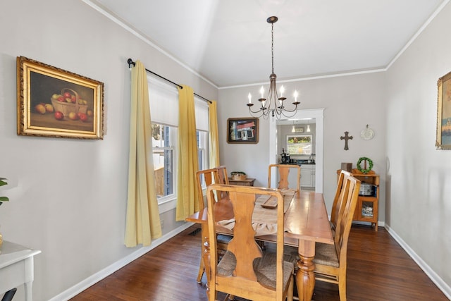 dining room with ornamental molding, dark wood-type flooring, and an inviting chandelier