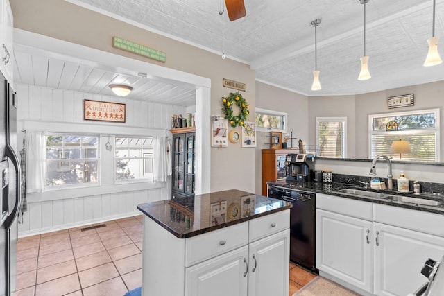 kitchen with sink, dishwasher, white cabinetry, decorative light fixtures, and dark stone counters