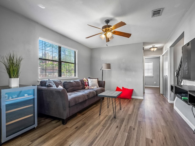 420 Indian Village Trl, Tallahassee, FL 32304 - living room featuring wine cooler, ceiling fan, wood finished floors, and baseboards