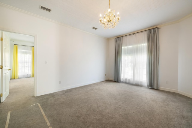 carpeted spare room featuring plenty of natural light and ornamental molding