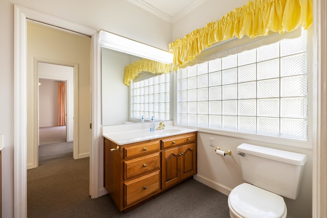 bathroom with toilet, vanity, and crown molding