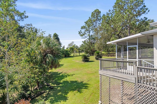 view of yard featuring a sunroom and a deck