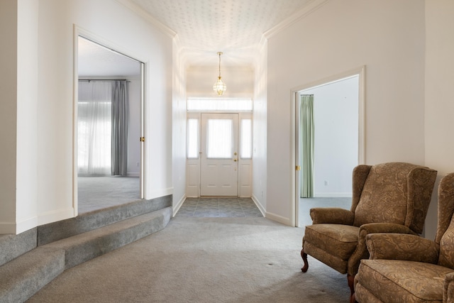 carpeted foyer entrance featuring crown molding