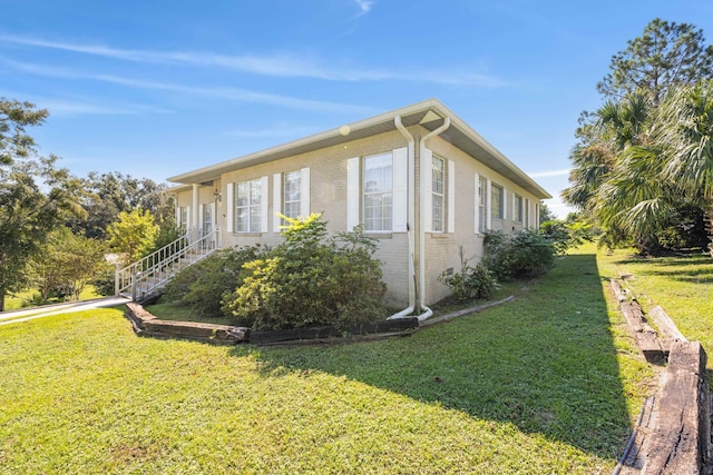 view of side of home featuring a lawn