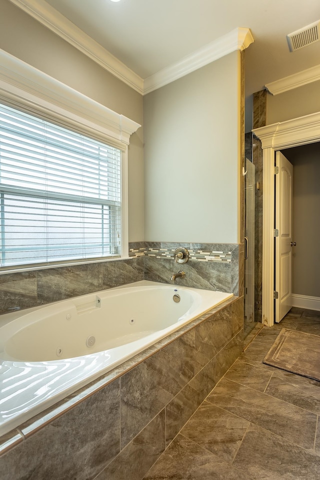 bathroom featuring ornamental molding and separate shower and tub