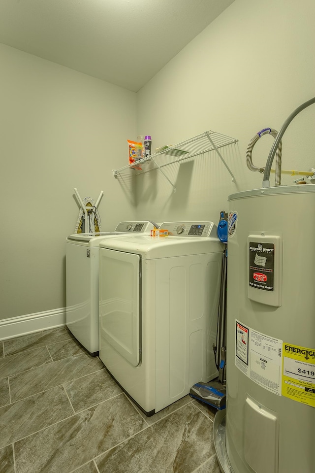 laundry room with washing machine and dryer and water heater