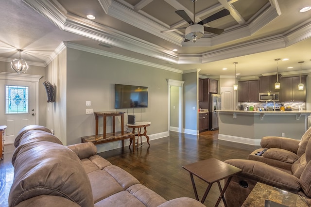 living room featuring ceiling fan with notable chandelier, a raised ceiling, ornamental molding, and dark hardwood / wood-style floors