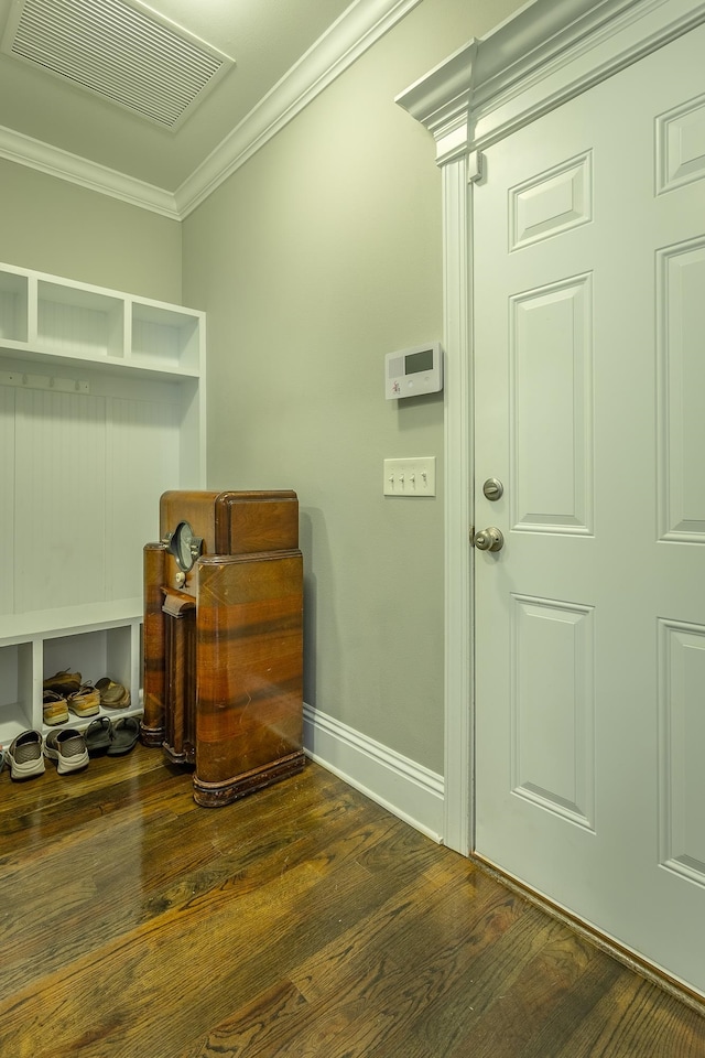 mudroom with dark wood-type flooring and crown molding