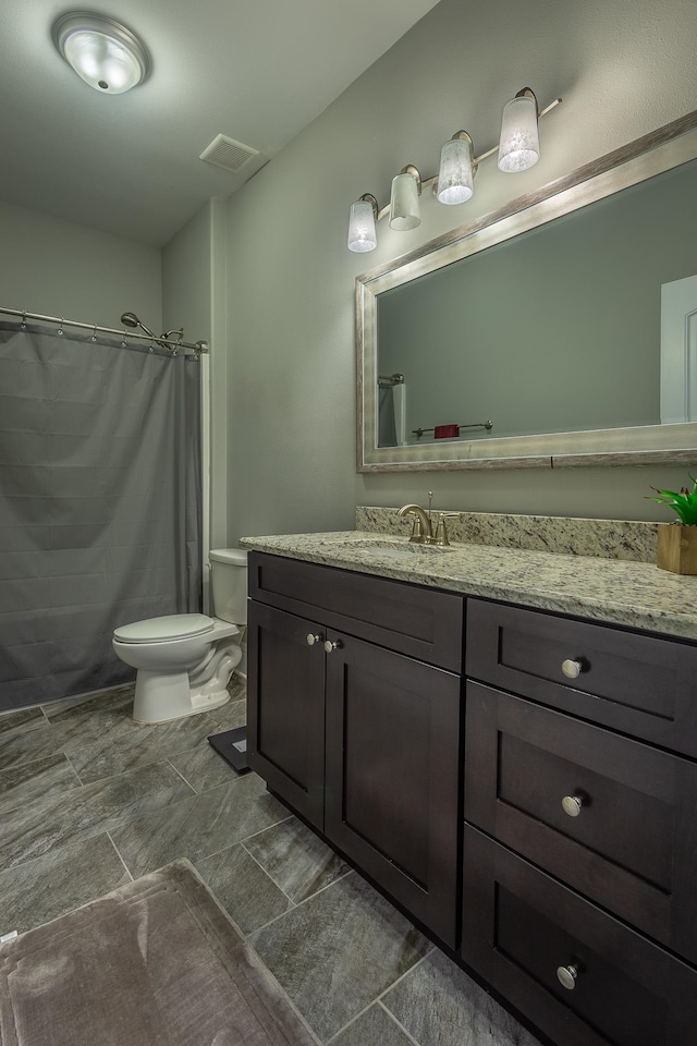 bathroom featuring vanity, toilet, and a shower with shower curtain