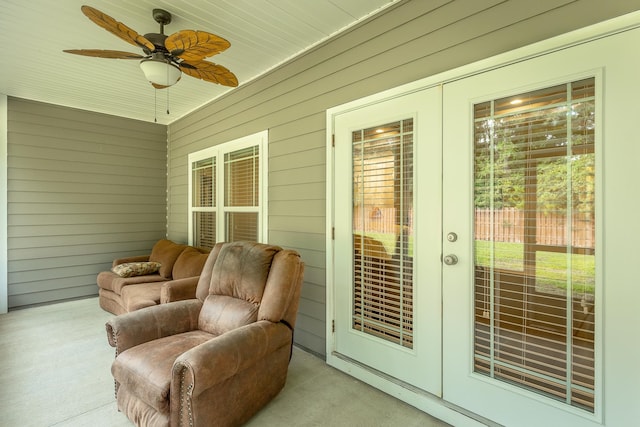 sunroom / solarium with ceiling fan and wood ceiling